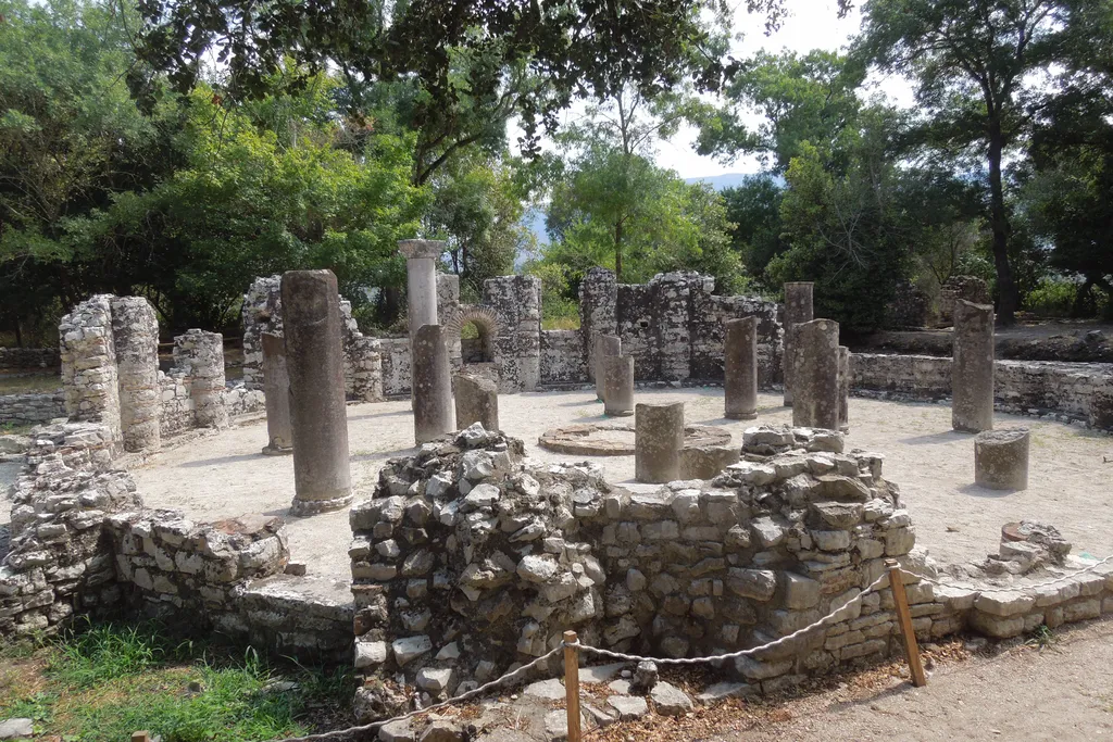 The circular baptistery at Butrint archaeological park in southern Albania, its columns standing among trees