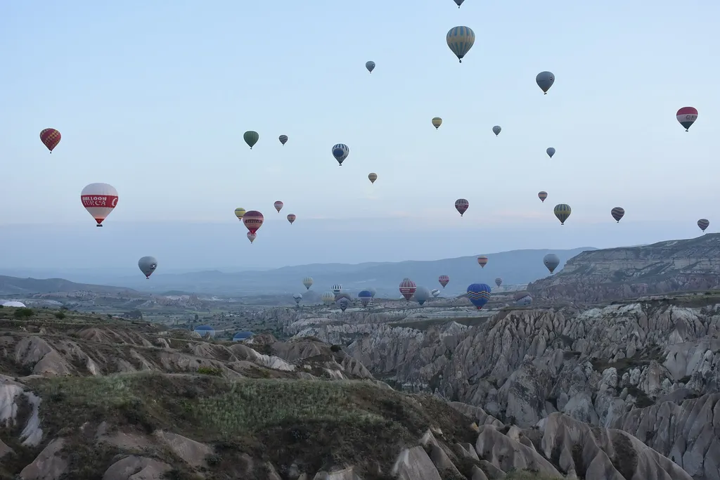 Hot air balloons floating over the valleys near Göreme, Cappadocia, in the early morning