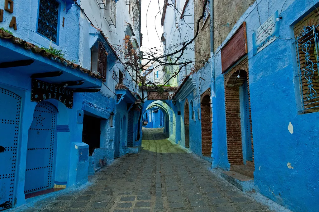 A narrow blue-painted street with a staircase in the old medina of Chefchaouen, Morocco