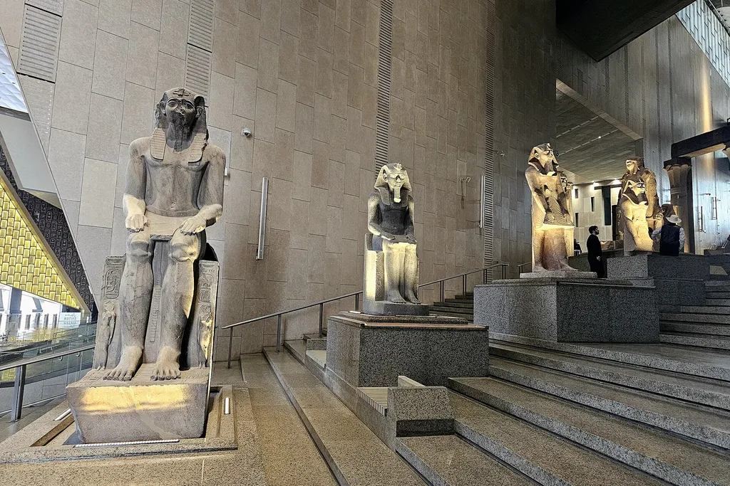 Royal statues lining the Grand Staircase of the Grand Egyptian Museum