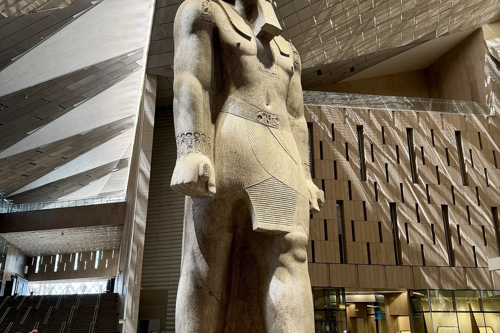 Colossal statue of Ramesses II standing in the Grand Hall of the Grand Egyptian Museum