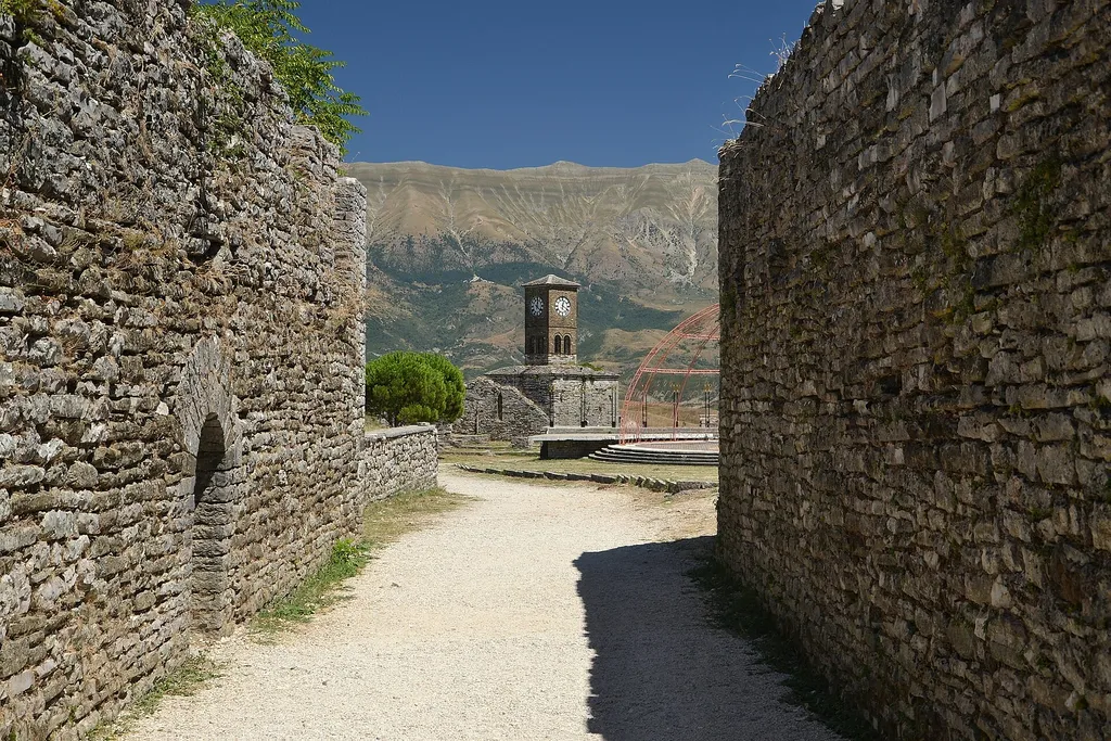 Inside Gjirokaster Castle in Albania, stone walls and the clock tower above the old town