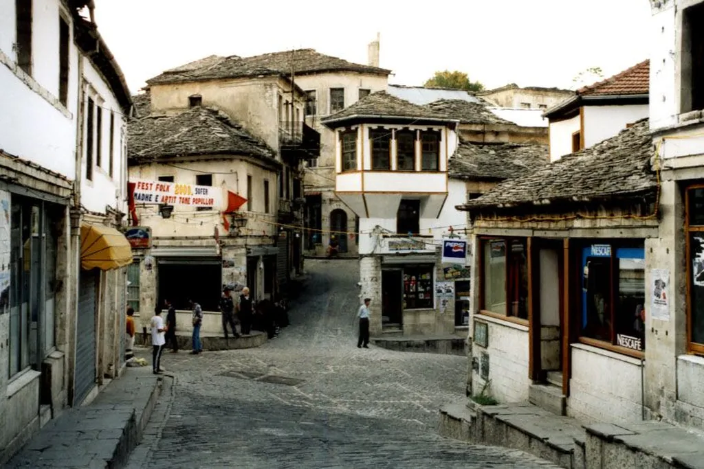 Cobbled street and slate-roofed Ottoman houses in the old town of Gjirokaster, Albania