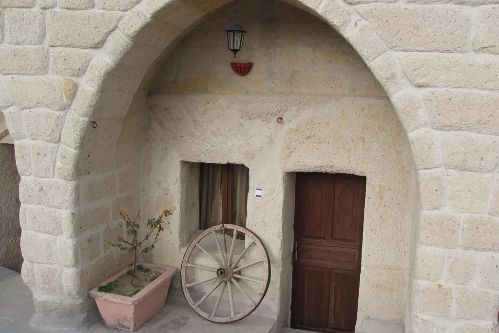 The carved stone doorway of a cave hotel room in Göreme, Cappadocia