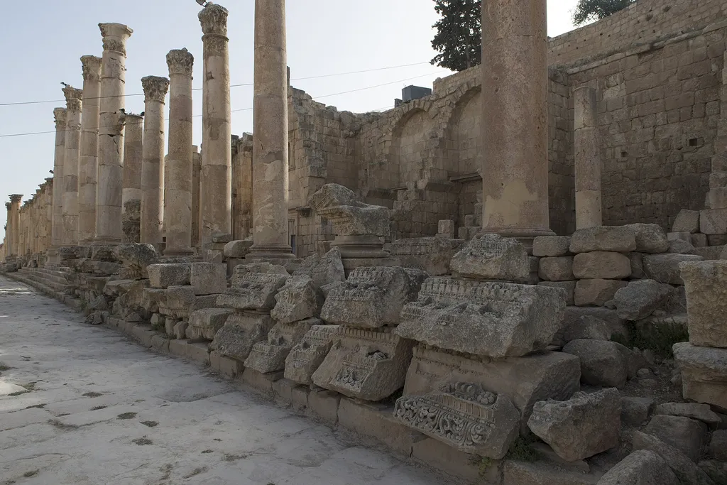 The colonnaded Cardo Maximus at Jerash, with fallen carved blocks along the street