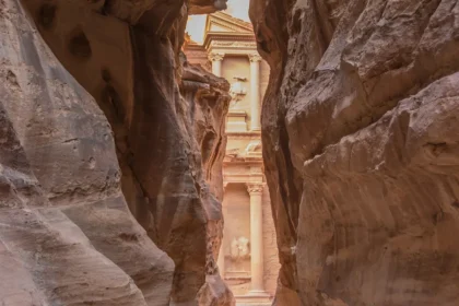 The Treasury at Petra framed by the dark walls of the Siq at the end of the gorge