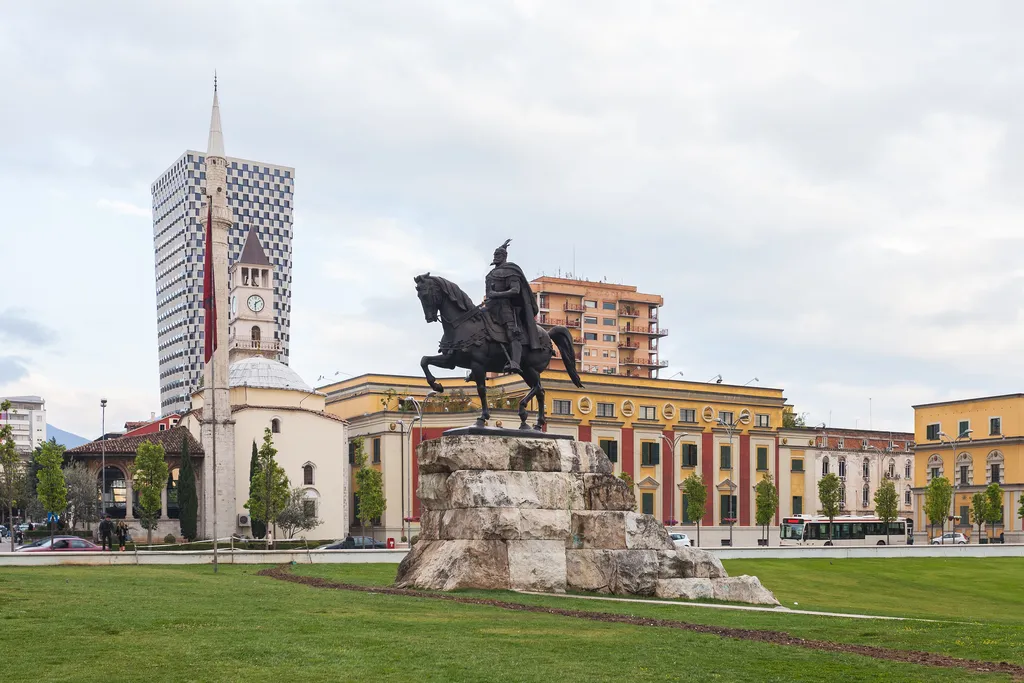 The Skanderbeg Monument in Skanderbeg Square, Tirana, with the Et'hem Bey Mosque and clock tower