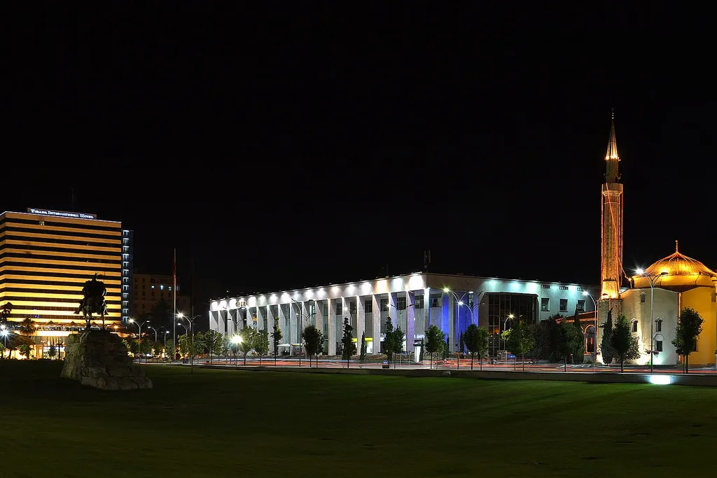 Skanderbeg Square in Tirana at night, with the Skanderbeg monument, the Palace of Culture and the Et'hem Bey Mosque illuminated