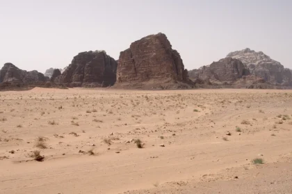 Sandstone mountains rising from the desert floor in Wadi Rum, Jordan
